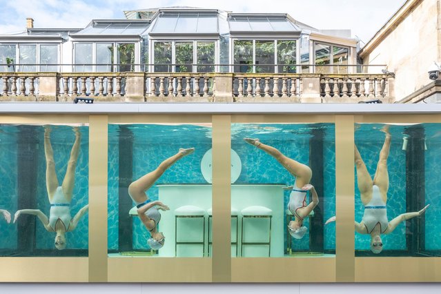 Synchronised swimmers, officially now known as Artistic Swimmers, comprising Emily Kuhl, Sisy Wong, Asha George and Katie Clark, perform in a specially built tank in Covent Garden in London on April 17, 2024 in a promotional event to mark 100 days until the start of the Paris Olympics. (Photo by Stephen Chung/Alamy Live News)