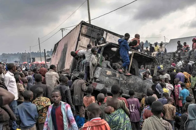 Residents dismantle a vehicle belonging to the United Nations Stabilization Mission in the Democratic Republic of Congo (MONUSCO) in Kanyaruchinya, Nyiragongo territory, Democratic Republic of Congo, February 8, 2023, after it was set on fire overnight by angry residents. At least three demonstrators were killed on February 7, 2023 in an attack on a UN convoy in eastern Democratic Republic of Congo, the United Nations mission in the country said in a statement. (Photo by Guerchom Ndebo/AFP Photo)