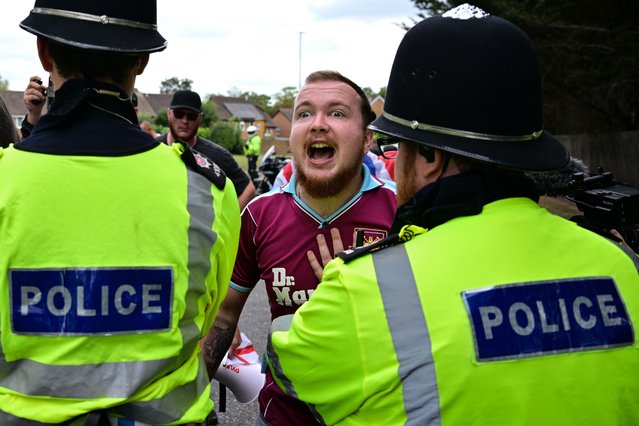 A demonstrator clashes with Police officers during an anti-immigration protest outside the Sheraton Four Points hotel, believed to be housing asylum seekers, in Horley, south of London, on August 23, 2025. A total of 111,084 people applied for asylum in the UK in the year to June 2025 -- the highest number ever. The figures come as Prime Minister Keir Starmer struggles to stem rising support for a hard-right party led by anti-immigrant firebrand Nigel Farage (Photo by Ben Stansall/AFP Photo)