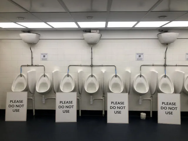 Signs display social distancing measures in a mens toilet on November 12, 2020 in London, United Kingdom. (Photo by Gareth Cattermole/Getty Images)