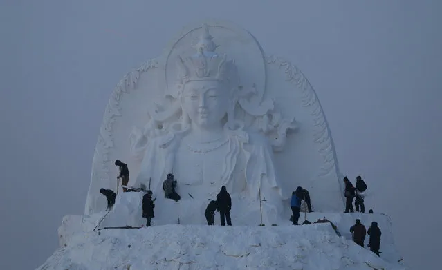 Sculptors work on a snow sculpture of Newton in the 16th Harbin Ice and Snow World, which will officially open on January 5 on December 22, 2014 in Harbin, China. (Photo by Feature China/Barcroft Media)