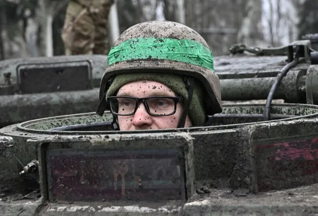 A Ukrainian serviceman looks out of the hatch of an armoured personnel carrier (APC) in the town of Chasiv Yar, Donetsk region on April 3, 2023, amid the Russian invasion of Ukraine. (Photo by Genya Savilov/AFP Photo)