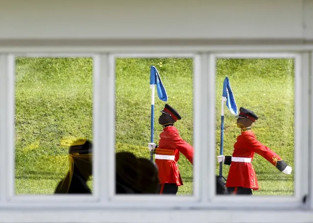 Kenyan military officers seen through a glass window at the presidential pavilion mount a guard of honor in respect of Pope Francis shortly before his departure from the Jomo Kenyatta International Airport, after a three day state visit Kenya's capital Nairobi November 27, 2015. (Photo by Noor Khamis/Reuters)