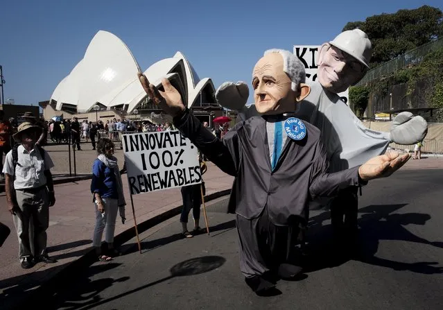 Giant puppets representing Australian Prime Minister Malcolm Turnbull (L) and his predecessor Tony Abbott parade in front of the Sydney Opera House during a rally held ahead of the 2015 Paris Climate Change Conference, known as the COP21 summit, in Sydney's central business district, Australia November 29, 2015. (Photo by Jason Reed/Reuters)