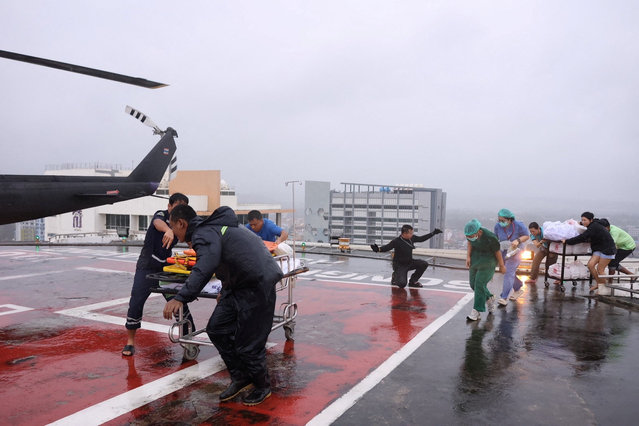 Medical crew carry a patient who is in critical condition, on a stretcher, as they transfer them to a military helicopter from Hat Yai Hospital to Songklanagarind Hospital, amid heavy flooding in Hat Yai district, which was affected by heavy rainfall impacting several provinces in southern Thailand and killing several people, in Songkhla province, Thailand, on November 26, 2025. (Photo by Royal Thai Army/Handout via Reuters)