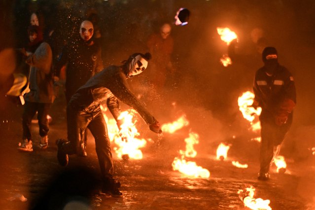Masked youth participate in the "Fireball Festival" in Nejapa, El Salvador, on August 31, 2024. The traditional festival, dating from 1922, is held in honour of Saint Jeronimo and recalls the 1658 eruption of the San Salvador volcano that destroyed Nejapa. (Photo by Marvin Recinos/AFP Photo)