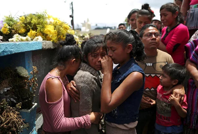 Relatives of Maria de Jesus Hernandez, who died during the eruption of the Fuego volcano, react during her funeral at a cemetery in Alotenango, Guatemala June 9, 2018. (Photo by Jose Cabezas/Reuters)