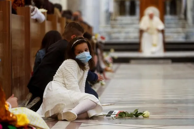 A girl sits down before Pope Francis holds a prayer at the Grand Immaculate Church in the town of Qaraqosh, Iraq, March 7, 2021. (Photo by Yara Nardi/Reuters)