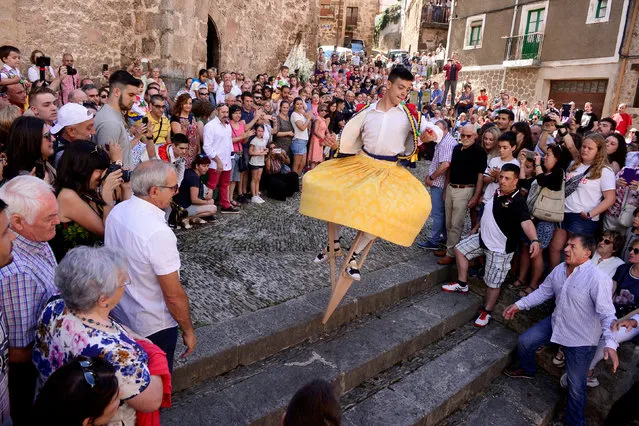 A skirt wearing dancer on stilts performs the whirling Dance of the Zancos on Saint Mary Magdalene's feast day in Anguiano, Spain, July 22, 2018. (Photo by Vincent West/Reuters)