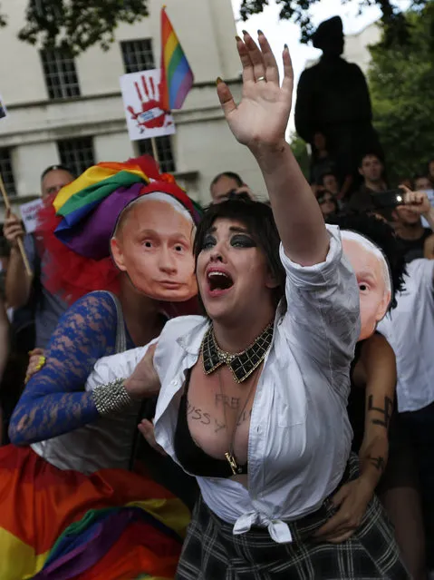 Activists stage a theatrical play where gays are prevented by others wearing masks depicting Russian President Vladimir Putin, during a protest against Russia's new law on gays, in central London, Saturday, August 10, 2013. Hundreds of protesters, called for the Winter 2014 Olympic Games to be taken away from Sochi, Russia, because of a new Russian law that bans “propaganda of nontraditional sexual relations” and imposes fines on those holding gay pride rallies. (Photo by Lefteris Pitarakis/AP Photo)