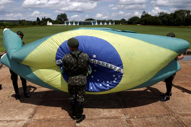 Soldier of presidential honor guards attend a ceremony outside the Alvorada Palace, in Brasilia, Brazil November 25, 2016. (Photo by Ueslei Marcelino/Reuters)