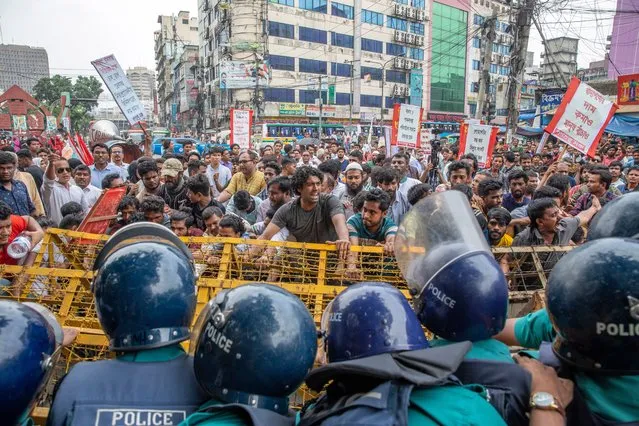 Policemen try to block members of Ganatantra Mancha leftist political parties' alliance during a march towards the Bangladesh Secretariat office in Dhaka, Bangladesh, 19 June 2023. The protesters are demanding an end to load shedding, power crisis and rising prices of food products among other demands. (Photo by Monirul Alam/EPA/EFE)