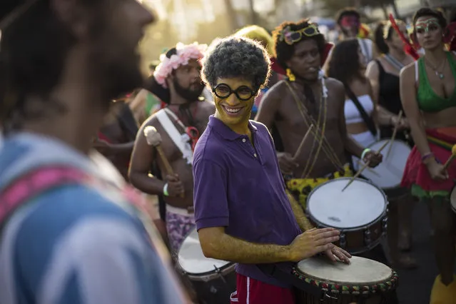 Revelers perform during the “Bloco Virtual” carnival parade at Leme Beach in Rio de Janeiro, Brazil, Friday, February 13, 2015. (Photo by Felipe Dana/AP Photo)