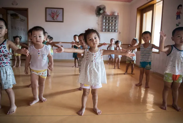 Employees children take part in a music and dance lesson at a kindergarten in the Kim Jong Suk Silk Factory on August 21, 2018 in Pyongyang, North Korea. (Photo by Carl Court/Getty Images)