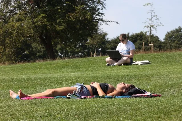 A person lays on Primrose Hill, London on Wednesday, August 16, 2023. (Photo by Matt Writtle/PA Images via Getty Images)