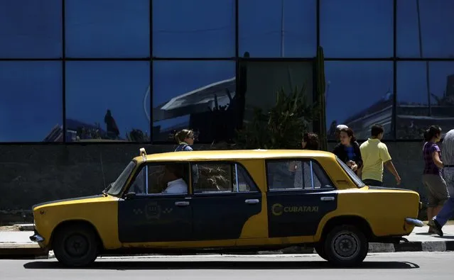 A man drives his taxi, a do-it-yourself stretch job performed on an old Soviet-era Russian car called Lada, in Havana March 30, 2010. From horse-drawn carts to 1950s Chevrolets, overcrowded sidecars to motorized bicycles, old military vans to a pair of Lada cars melded into one, anything goes on the roads of Cuba, a virtual living transport museum. (Photo by Desmond Boylan/Reuters)