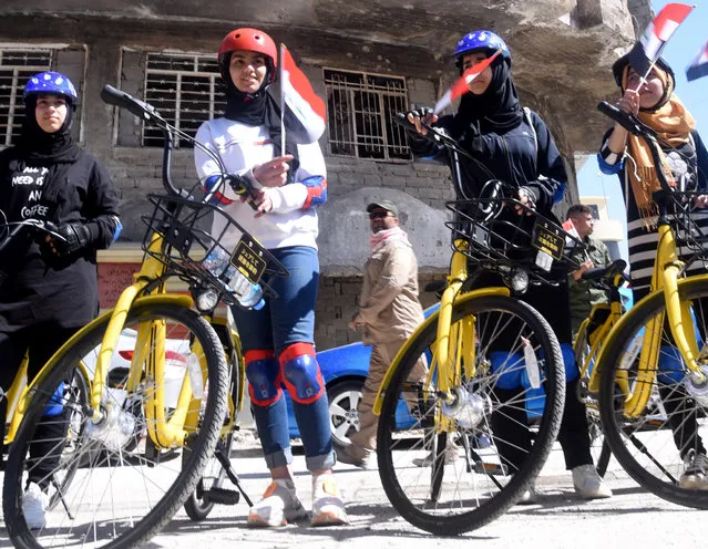 Iraqi cyclists pose next to their bikes before taking part in the first all female Mosul cycling race, Mosul, Iraq, 12 April 2021. Some 35 female riders from all over the Nineveh Province, with ages ranging from 15 to 30 years old, took part in a first race of its kind through the streets of the damaged old City of Mosul on 12 April. The event's starting point was the Great Mosque of al-Nuri, a famous landmark that became even more known after being the location of IS leader speech announcing self-declared Caliphate, when IS controlled Mosul. The race was organized by a section of the Iraqi Ministry of Youth and Sports and an Italian NGO "UPP" (Un Ponte Per-A bridge for) which promotes solidarity initiatives in favor of Iraqi people who suffered from the conflict as well German Cooperation and other organizations. The event ended with medals to all participants and aims at helping initiate attitude change in a generally conservative Iraqi society, about female usage of bicycles and to bring attention to the need of more reconstruction efforts in the war torn city of Mosul especially its old parts which were the theater of fierce fighting to drive out IS fighters from the town. (Photo by Omar Alhayali/EPA/EFE)