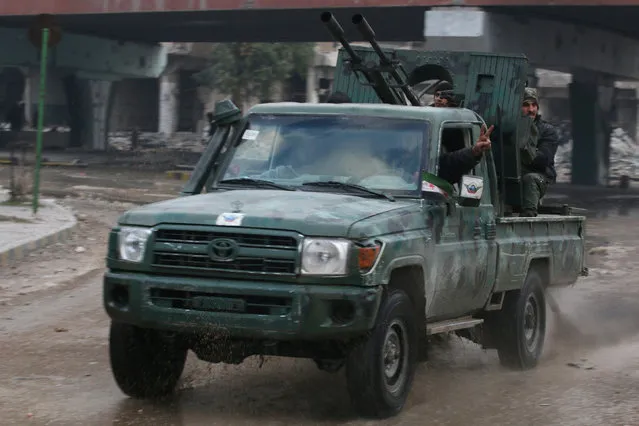 Rebel fighters ride on a pick-up truck mounted with a weapon as they drive in a rebel-held area of Aleppo, Syria December 7, 2016. (Photo by Abdalrhman Ismail/Reuters)