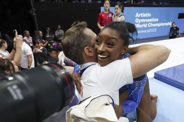 United States' Simone Biles celebrates with her coach after winning the gold medal during the women's all-round final at the Artistic Gymnastics World Championships in Antwerp, Belgium, Friday, October 6, 2023. (Photo by Geert Vanden Wijngaert/AP Photo)