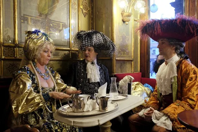 Revellers are seen in the Caffe Florian coffee shop in Saint Mark's Square during the Venice Carnival, Italy January 31, 2016. (Photo by Manuel Silvestri/Reuters)