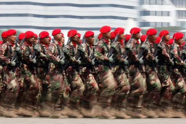 Indonesian Military Special Forces personnel march during the 78th Indonesian Military Anniversary ceremony at the National Monument (Monas) complex in Jakarta, Indonesia on October 5, 2023. (Photo by Willy Kurniawan/Reuters)