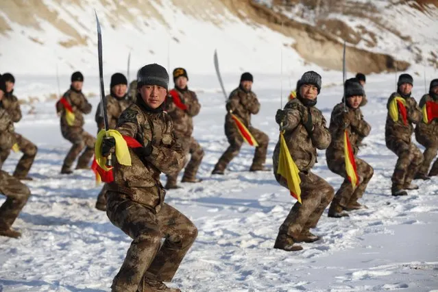 Soldiers of China's People's Liberation Army (PLA) take part in winter training at temperatures around negative 30 degrees Celsius (minus 22 degrees Fahrenheit) at China's border with Russia in Heihe, Heilongjiang province, January 31, 2016. (Photo by Reuters/China Daily)