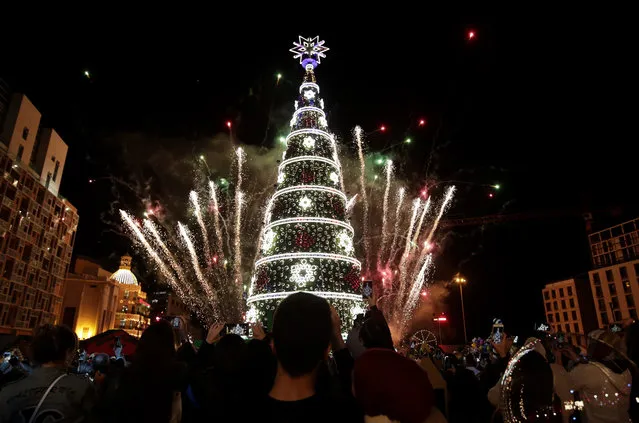 Fireworks light the sky as a Christmas is lit in Lebanon's capital Beirut on December 3, 2018. (Photo by Anwar Amro/AFP Photo)