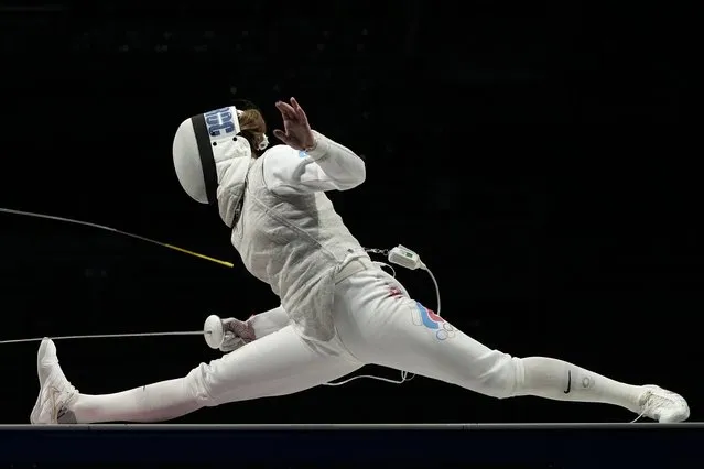 Marta Martyanova of the Russian Olympic Committee and Astrid Guyard of France compete in the women's individual Foil team final medal competition at the 2020 Summer Olympics, Thursday, July 29, 2021, in Chiba, Japan. (Photo by Hassan Ammar/AP Photo)