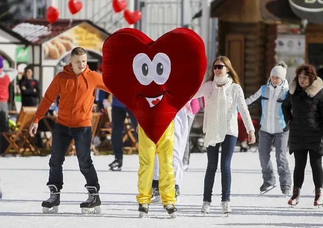 A skater wearing a heart-shaped costume skates during a Valentine's Day celebration at the Medeo skating rink in Almaty, Kazakhstan, February 14, 2016. (Photo by Shamil Zhumatov/Reuters)