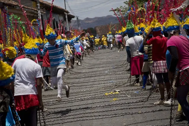 People representing Judas carry chains during the “Los Encadenados”, or The Chained Ones, procession on Good Friday during Holy Week in Masatepe, Nicaragua, Friday, April 3, 2015. (Photo by Esteban Felix/AP Photo)