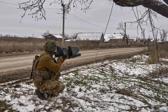 In this photo provided by the Ukrainian 10th Mountain Assault Brigade “Edelweiss”, a Ukrainian soldier holds an anti-drone gun on his position near Bakhmut, Donetsk region, Ukraine, Thursday, November 23, 2023. (Shandyba Mykyta, Ukrainian 10th Mountain Assault Brigade “Edelweiss” via AP)