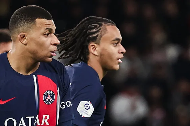 Paris Saint-Germain's French forward #07 Kylian Mbappe and Paris Saint-Germain's midfielder #38 Ethan Mbappe look on during the French L1 football match between Paris Saint-Germain (PSG) and FC Metz at the Parc des Princes stadium in Paris, on December 20, 2023. (Photo by Franck Fife/AFP Photo)