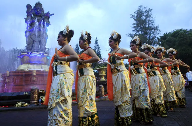 Balinese girls in traditional costumes dance during a parade for this year's last sundown in Bali island, Indonesia on New Year's Eve, Tuesday, December 31, 2013. (Photo by Firdia Lisnawati/AP Photo)