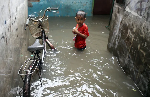 A child walks in the flooded street. Continuous rain for almost two days now caused flood to the densely populated areas in the North Kedoya area, Jakarta, Indonesia on February 26, 2016. (Photo by Natanael Pohan/Pacific Press via ZUMA Wire)