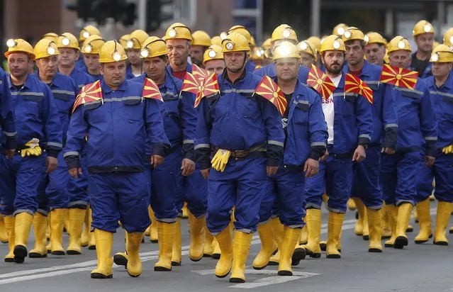 Miners take part in a parade during the Independence Day in downtown Skopje, North Macedonia, Wednesday, September 8, 2021. (Photo by Boris Grdanoski/AP Photo)