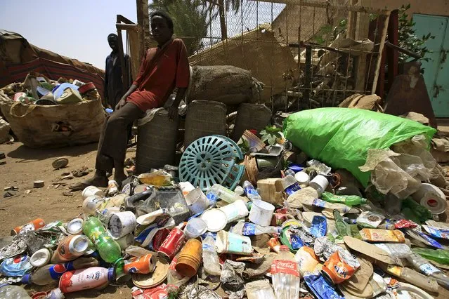 Boys wait next to plastic materials they brought to a recycling station in Khartoum North April 16, 2015. (Photo by Mohamed Nureldin Abdallah/Reuters)