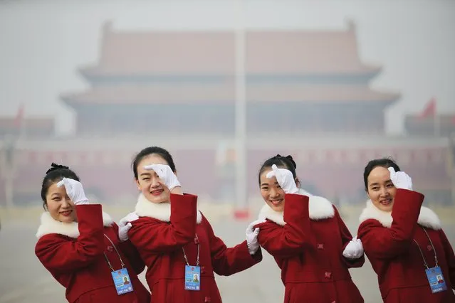 Hostesses pose for pictures at the Tiananmen Square during the opening session of the Chinese People's Political Consultative Conference (CPPCC) at the near-by Great Hall of the People in Beijing, China, March 3, 2016. (Photo by Damir Sagolj/Reuters)