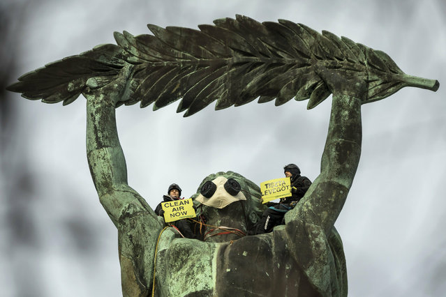 Environmental activists of Greenpeace demonstrate against the capital's air pollution on the statue of Freedom on top of Gellert Hill in Budapest, Hungary, Tuesday, February 26, 2019. (Photo by Balazs Mohai/MTI via AP Photo)