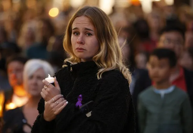 A woman cries as she attends a vigil for murdered 28-year-old teacher Sabina Nessa in Kidbrooke in south-east London, Friday, September 24, 2021. Nessa's killing has renewed concerns that women are not safe on the city's streets, and a vigil is taking place in her memory on Friday. Late Thursday police said they had arrested a man in a nearby area of London on suspicion of murder. He has not been charged, and his name was not released. (Photo by David Cliff/AP Photo)