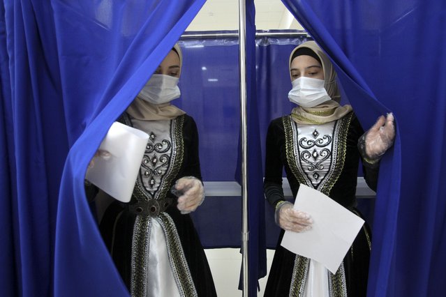 Chechen women weared Chechen national costumes leave a polling booth at a polling station during the Parliamentary elections in Grozny, Russia, Sunday, September 19, 2021. (Photo by Musa Sadulayev/AP Photo)