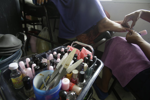 In this Jan. 6, 2017 photo, transgender inmates learn how to paint nails during a lesson at Pattaya Remand Prison in Pattaya, Chonburi province, Thailand. The prison separates lesbian, gay, bisexual and transgender prisoners from other inmates, a little-known policy despite being in place nationwide since 1993, according to the Department of Corrections. (AP Photo/Sakchai Lalit)