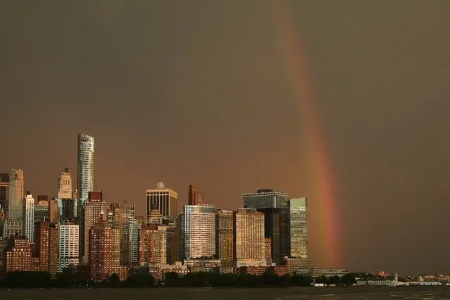A rainbow is seen in the sky above Lower Manhattan area of New York from across the Hudson River on the 22th anniversary of the 9/11 terror attacks, Monday, September 11, 2023, in Jersey City, N.J. (Photo by Andres Kudacki/AP Photo)