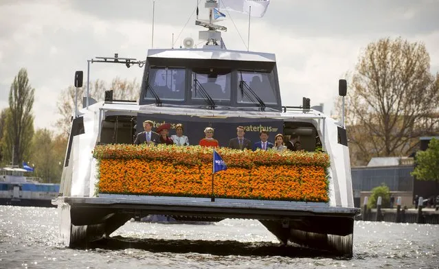 King Willem-Alexander (L) and Queen Maxima (2nd L) of the Netherlands enjoy a boat trip with their family on King's Day in Dordrecht April 27, 2015. The Dutch are celebrating King's Day, a national holiday held in honour of the Netherlands' monarch, King Willem-Alexander. (Photo by Frank van Beek/Reuters)