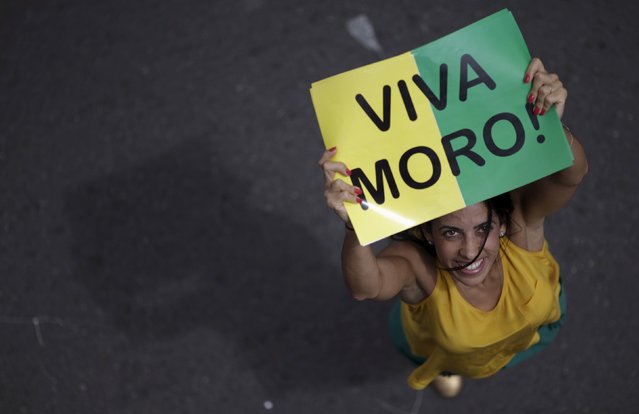 A demonstrator shows a poster “Viva Moro” in support of Federal Judge Sergio Moro during a protest against Brazil's President Dilma Rousseff, part of nationwide protests calling for her impeachment, in Brasilia, Brazil, March 13, 2016. (Photo by Ueslei Marcelino/Reuters)