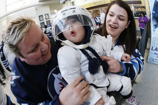 Winnipeg Jets fans Corie, Erica and Chantelle Naugle are dressed in white – some more than others – as they arrive for Game 4 of a first-round NHL hockey playoff series between the Jets and the Anaheim Ducks, Wednesday, April 22, 2015, in Winnipeg, Manitoba. (Photo by John Woods/The Canadian Press via AP Photo)