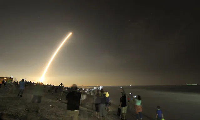 Cell phones light up the beaches of Cape Canaveral and Cocoa Beach, Fla., north of the Cocoa Beach Pier as spectators watch the launch of the NOAA GOES-R weather satellite, Saturday, November 19, 2016. It was launched from Launch Complex 41 at Cape Canaveral Air Force Station on a ULA Atlas V rocket. (Photo by Malcolm Denemark/Florida Today via AP Photo)