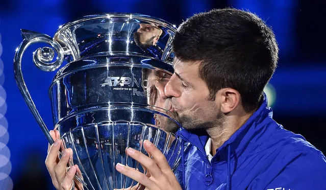 Novak Djokovic of Serbia kisses the ATP World Tour No. 1 Award trophy he received for the seventh time during the Nitto ATP Finals tennis ​tournament in Turin, Italy, 15 November 2021. (Photo by Alessandro Di Marco/EPA/EFE)