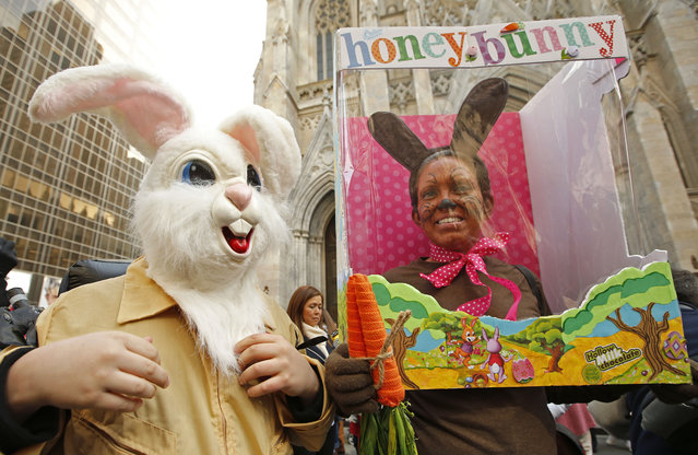 Maxwell Kalba and Judth Stuck, of West Hempstead, N.Y., pose for photographers during the annual Easter parade along Fifth Avenue in front of St. Patrick's Cathedral, Sunday, March 27, 2016, in New York. Stuck admitted Maxwell, 12, was tiring of wearing his rabbit head costume because it was so heavy. (Photo by Kathy Willens/AP Photo)