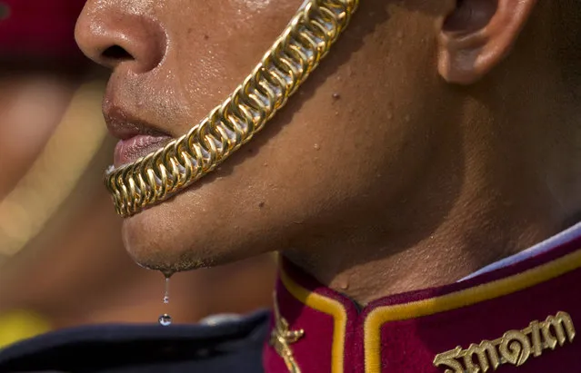 A solders in ceremonial attire sweats as he waits outside Suddhaisavarya Prasad Hall, in which Thailand's King Maha Vajiralongkorn scheduled to grant a public audience in Bangkok, Thailand, Monday, May 6, 2019. King Maha Vajiralongkorn was officially crowned amid the splendour of the country's Grand Palace, taking the central role in an elaborate centuries-old royal ceremony that was last held almost seven decades ago. (Photo by Gemunu Amarasinghe/AP Photo)