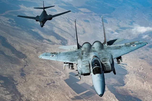 In this photo released by the U.S. Air Force, an Israeli Air Force F-15 Strike Eagle flies in formation with a U.S. Air Force B-1B Lancer over Israel as part of a deterrence flight Saturday, October 30, 2021. (Photo by Senior Airman Jerreht Harris/U.S. Air Force via AP)